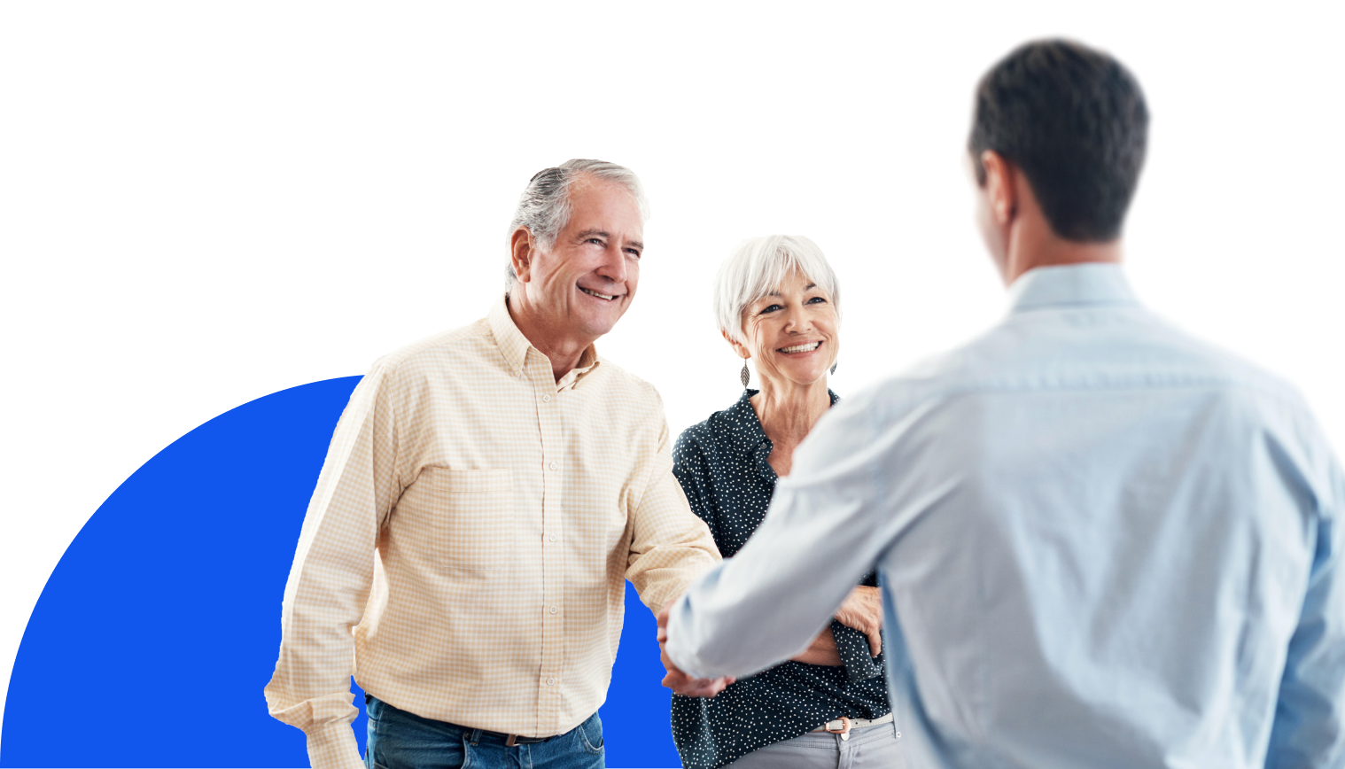 Smiling man and smiling woman facing us and shaking hands with a man who is facing away from us