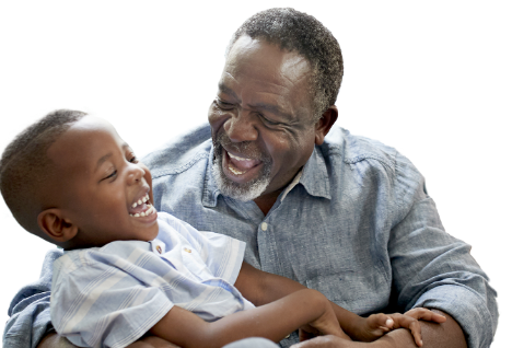 Man in yellow shirt with his hands clapped together while he looks up and smiles