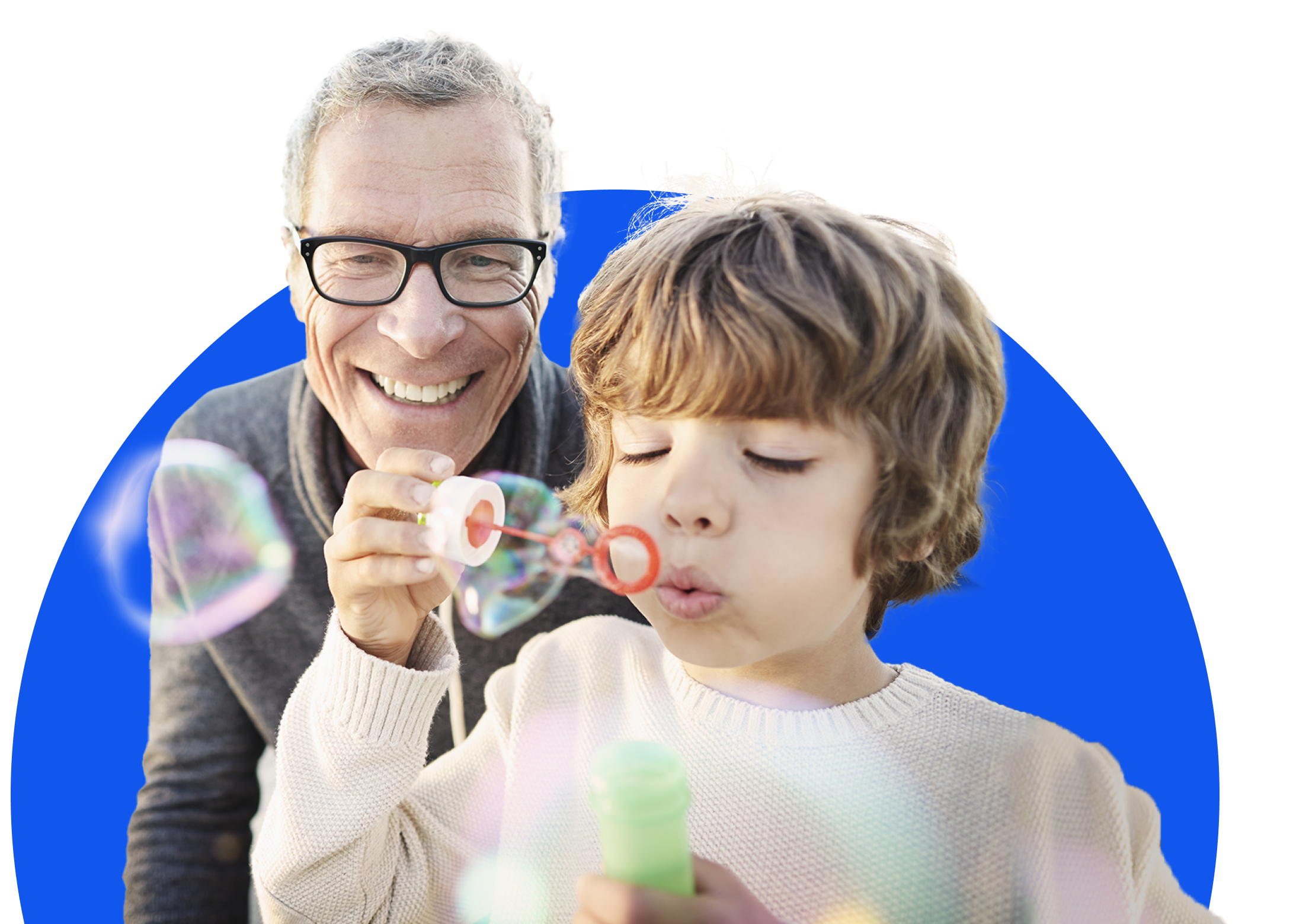 Man in gray shirt smiling with arm around smiling woman in a red striped shirt